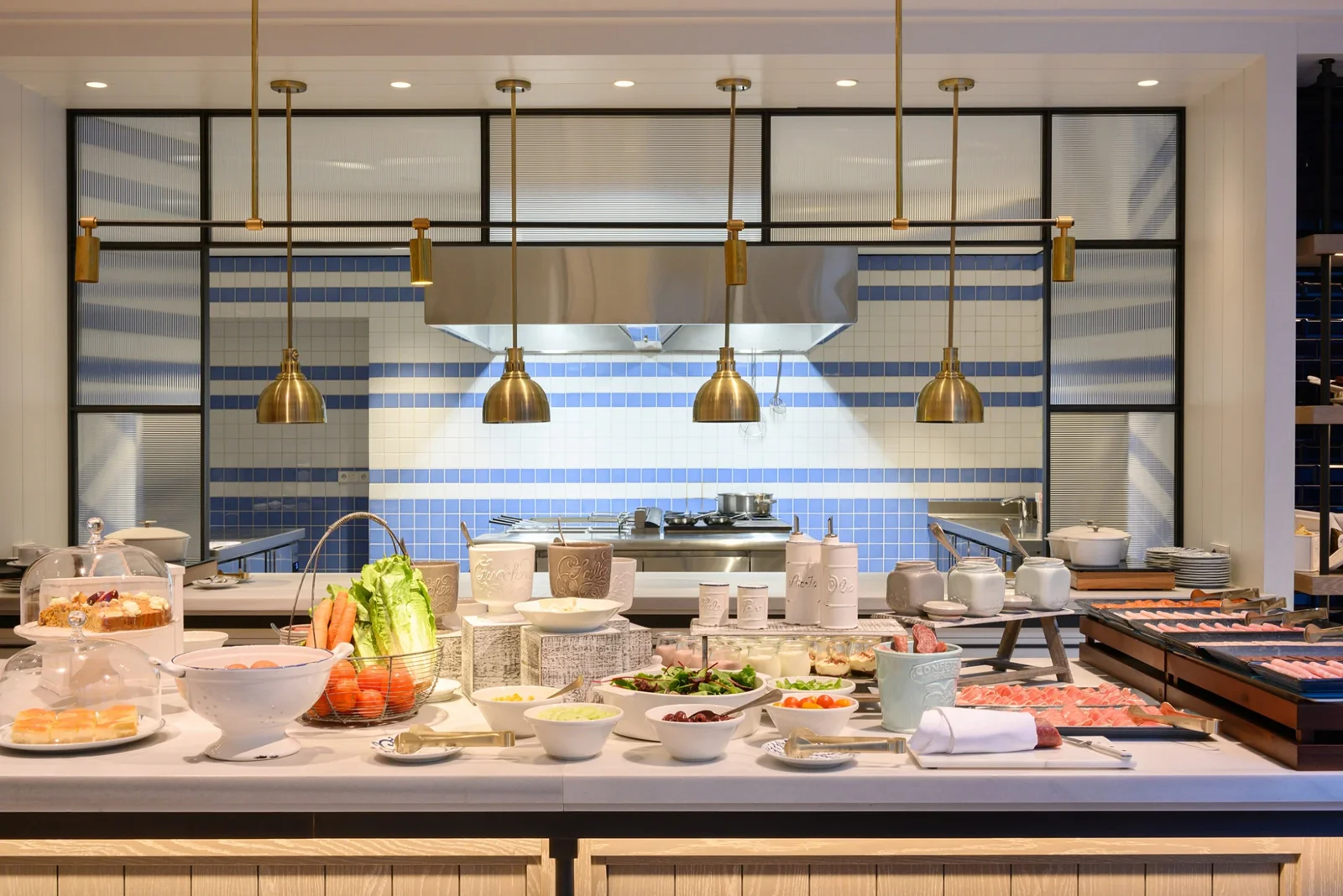 The breakfast buffet laid out under its brass pendant lights