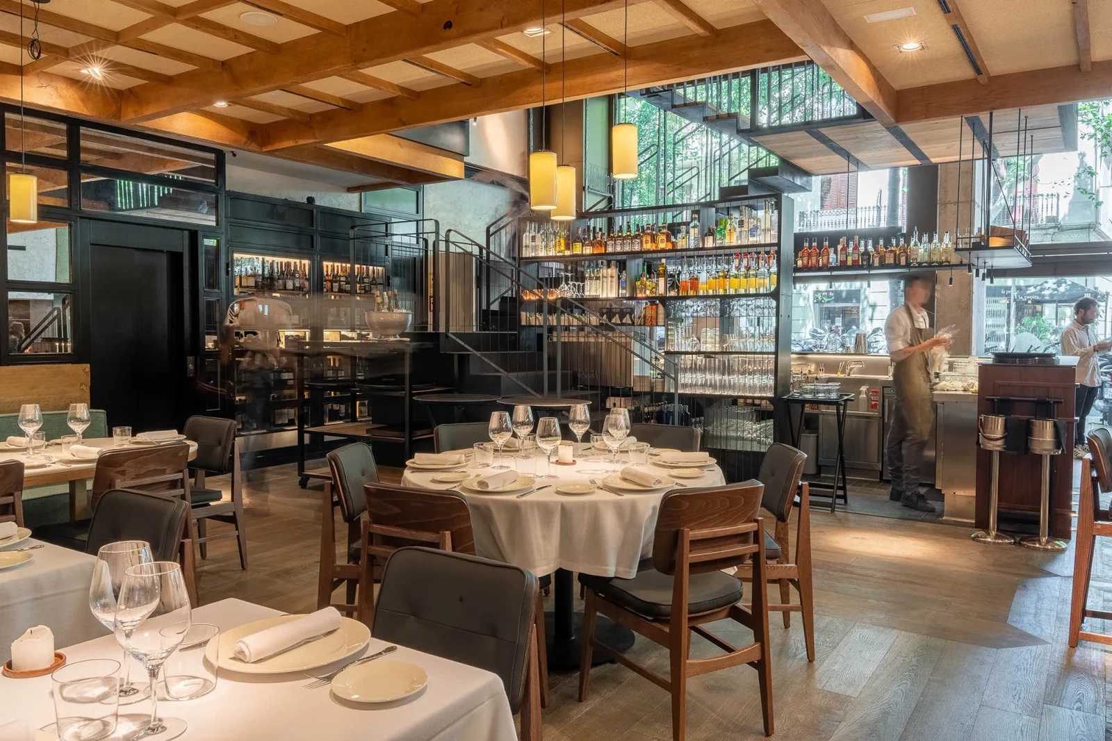 The dining room, tables set beneath the bar