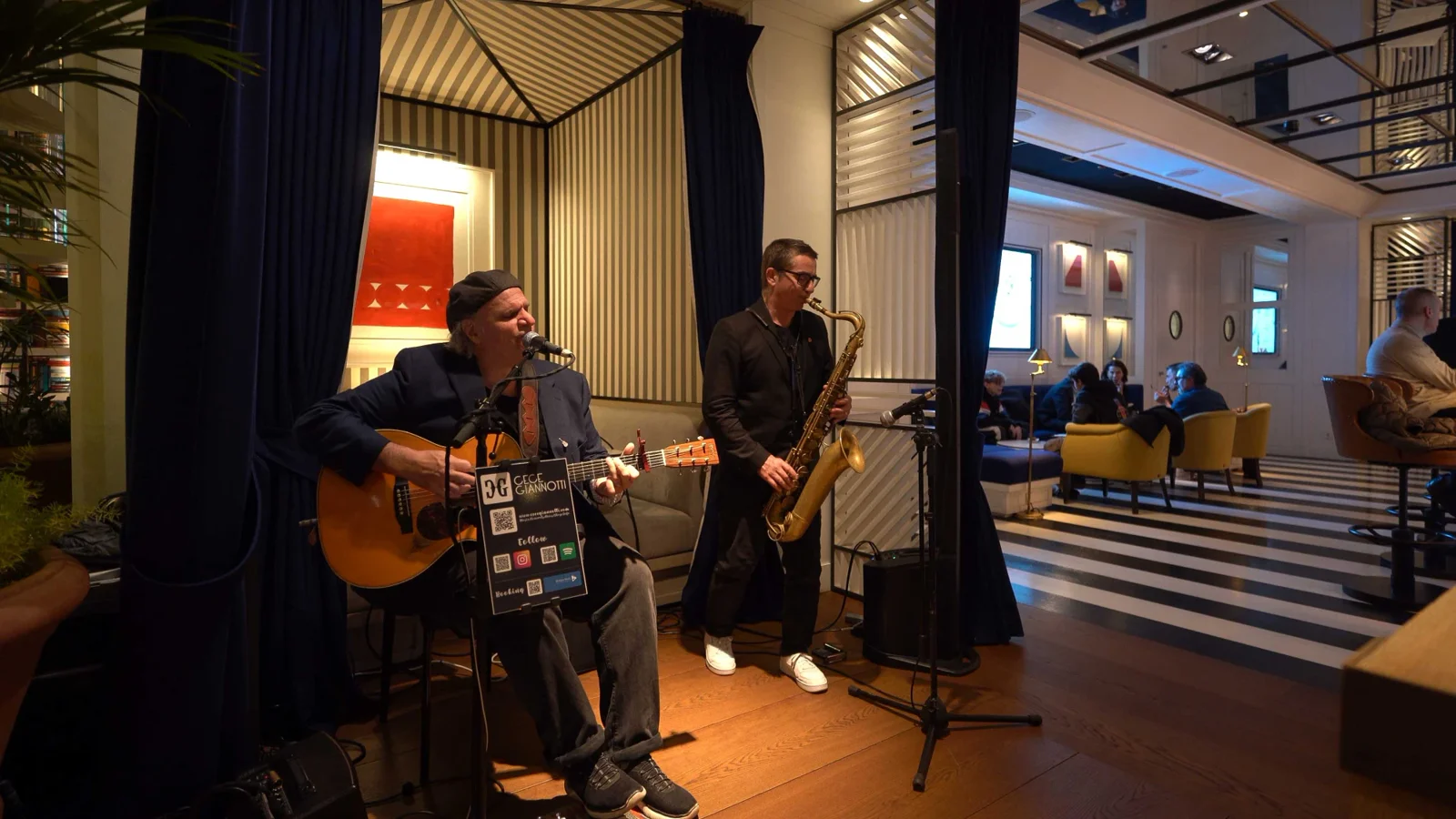 A guitarist and saxophonist playing live in The Cors lounge